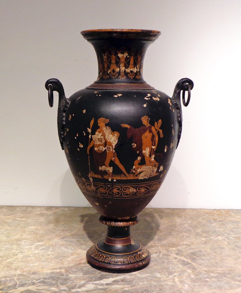 A “Grand Tour”
Cast Iron Etruscan Vase 
19th Century

Depicting classical Greek figures, with ring handles with a leaf motif on each side.

Height 20 in.

Vas INV. 9
