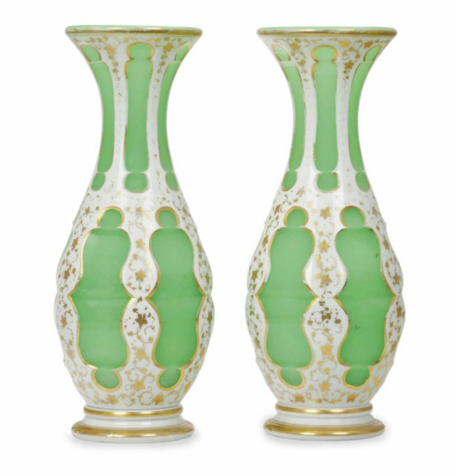 A pair of gilt decorated Bohemian white and green pear-form vases.
19th or 20th century.

Decorated with vines surrounding cartouches.

Measures: Height 11 in.

Provenance:
Property of a New York Collection
Le Trianon Fine Art & Antiques,