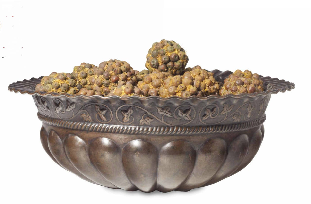 A fine large sise repousse patinated.
Metal bowl.
20th century.

Together with a group of nut and moss pomander balls.

Height 10 in. Diameter 29 in. 

Provenance:
Property from a Private Connecticut Collection.
Le Trianon Fine Art &