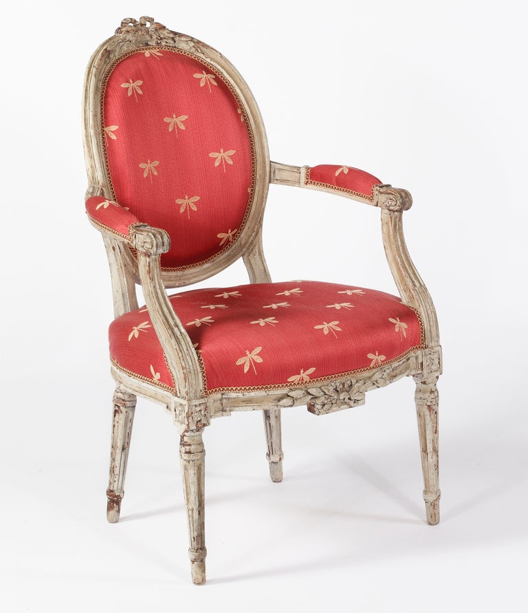 A Set of Four Louis XVI
Grey Painted Fauteuils a la Reine
18th Century

Each oval back with bow-knotted laurel crest, the padded arms on s-scroll supports,
and the bow-fronted seat above laurel carved rail, raised on stop fluted legs

Height 39 in.