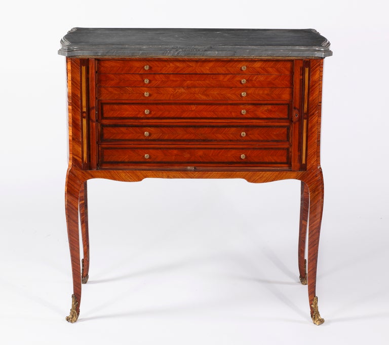 A Fine Louis XV Ormolu mounted Tulipwood, Kingwood & Parquetry Collectors Cabinet
Mid 18th Century
Attributed to Jean-François Oeben

The shaped marble top over a shaped cabinet with tulipwood, kingwood & parquetry throughout, with tambour shutters