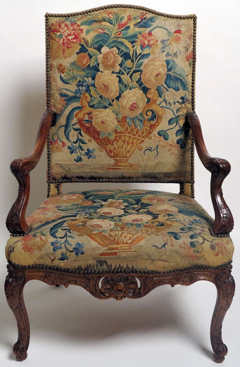 A Fine Pairof Late Regence/LouisXV,Beechwood Walnut Stained
Fauteuils A La Reine
18th Century

Upholstered in Aubusson Tapestry Woven with Flwer filled Vases
Each with a pierced shell seatrail

Height 42 ½ in.  Width 26 ½ in.  Depth 23