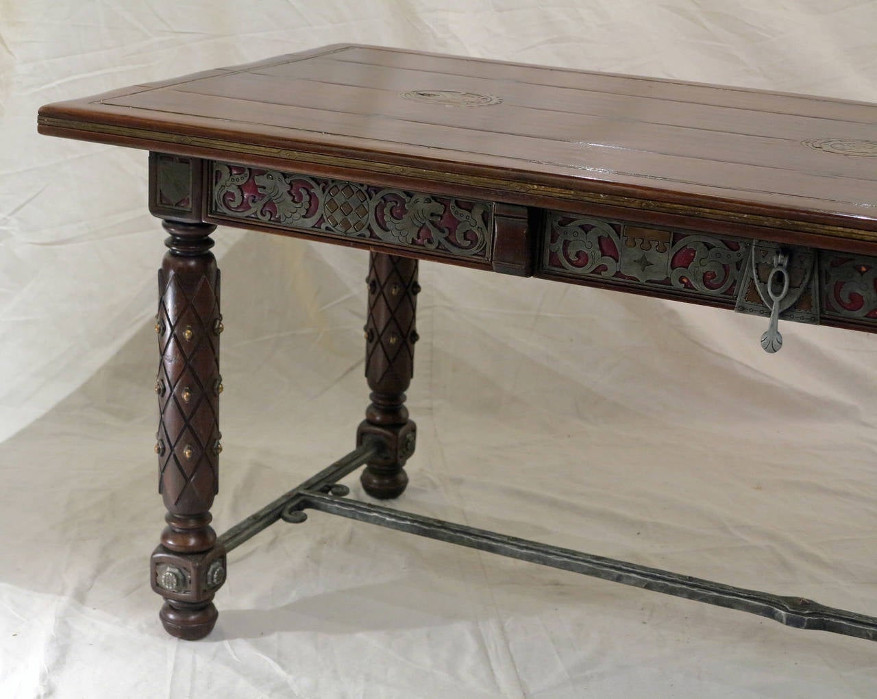 An Exceptional & Rare Medieval Style Center/Library Table
Late 19th Century

Inlaid throughout with different types of metals (pewter, copper, bronze, iron)
featuring three highly decorated drawers, seating on 4 bronze decorated legs ending on