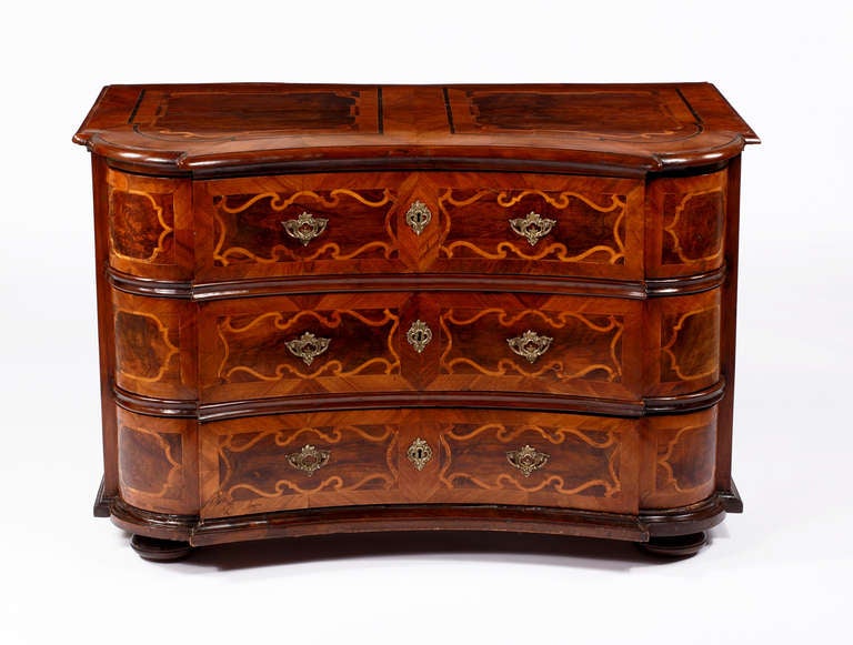 A Fine German Baroque Walnut & Parquetry Commode
Circa 1680-1720

The serpentine top with various wood parquetry designs throughout over a shaped case 
with three serpentine drawers, all resting on bun feet.

Height 32 ½ in.  Width 50 ½ in. 