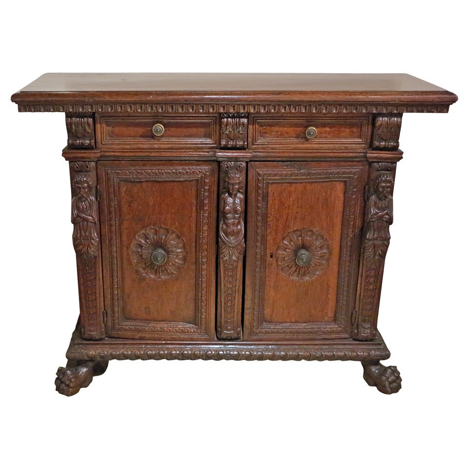 An Italian Renaissance
Walnut Credenza
17th Century

The rectangular top with a carved edge over two drawers and two cupboard doors with a carved central motif, flanked by three figures over a carved base all ending on carved paw feet.

Height 45