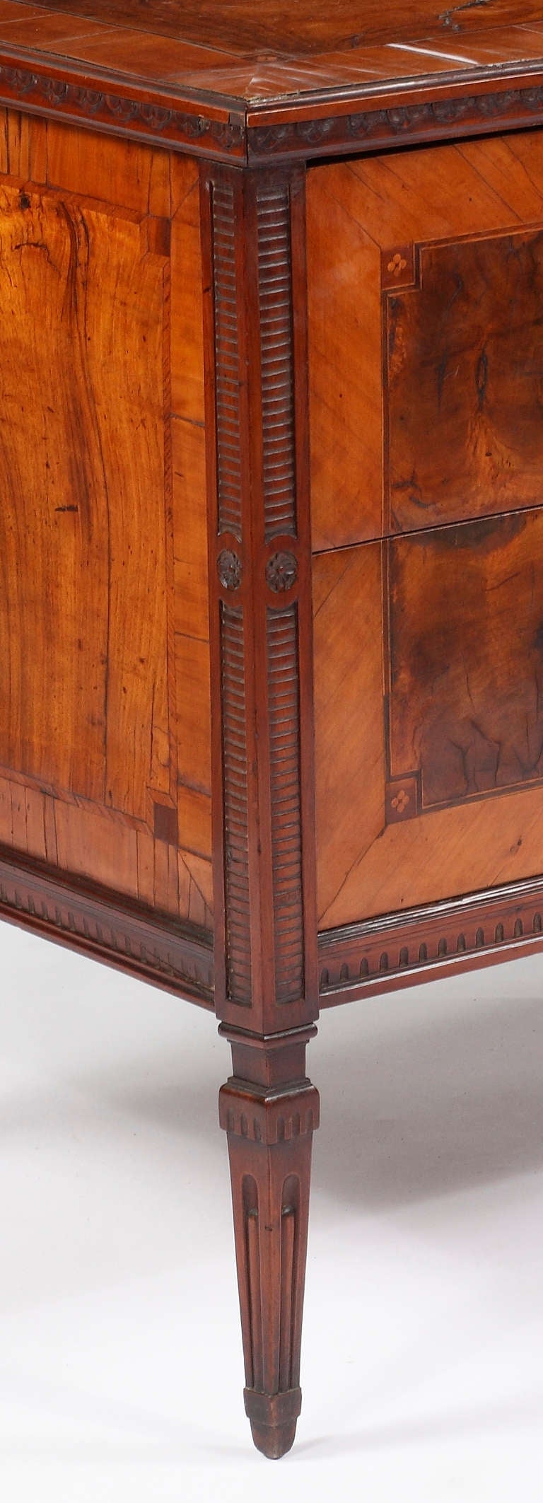 A Fine & Rare Italian Neoclassic 
Burr Walnut and Inlaid Commode
Possibly Milan
Circa 1780

The inlaid rectangular top with a carved frieze, 
over two drawers all on carved tapering legs

Height 32 in.   Width 43 ¼ in.   Depth 24 in.

Com 5