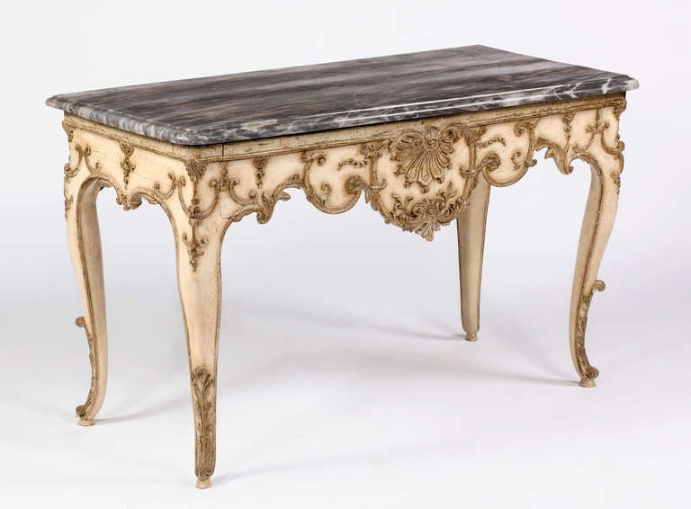 A Fine Regence Polychrome Console Table
First Quarter of the 18th Century

The rectangular marble top with rounded corners and molded edge above a shell and foliate scroll carved cabriole legs

Height 35 in. Width 58 in.  Depth 28