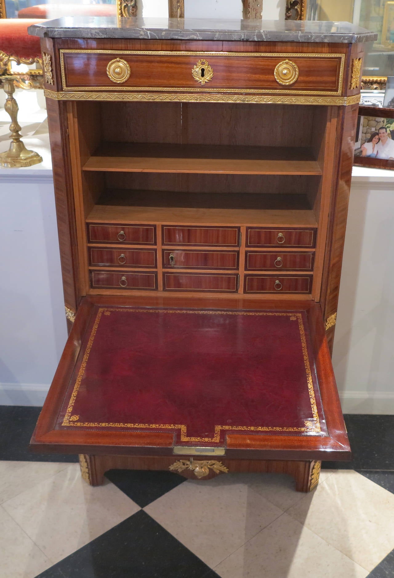 A Louis XVI Ormolu-Mounted 
Kingwood & Tulipwood Secretaire a Abattant
By Martin Ohneberg
18th Century

The shaped white-veined grey marble top above a fitted with a drawer and a fall-front centred by an oval medallion, the reverse with a