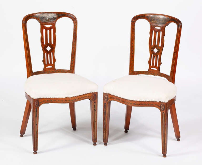Each with a molded hooped backrest with pierced splat,
the padded serpentine seat raised on fluted straight legs