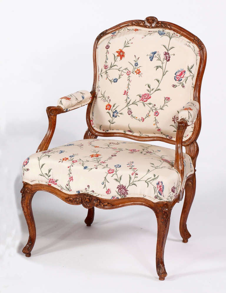 A Fine Pair of Louis XV Beechwood Fauteuils a la Reine
Mid 18th Century
Stamped Nicolas Blanchard, maitre in 1771

Each with a cartouche shaped upholstered backrest, the top rail carved with flowerheads and leaf tip, padded armrests raised on