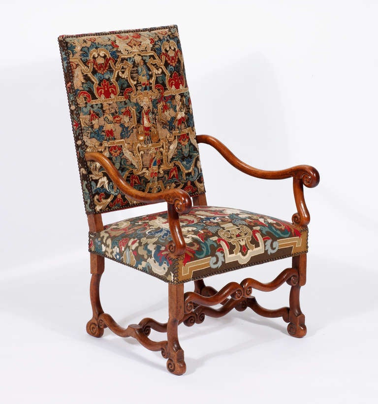 A Fine Pair of Louis XIV Walnut Armchairs 
Early18TH Century

Each with rectangular back and seat covered with scrolling arms in later period close-studded gros-point needlework on 'os de mouton' legs joined by similar ogee arched