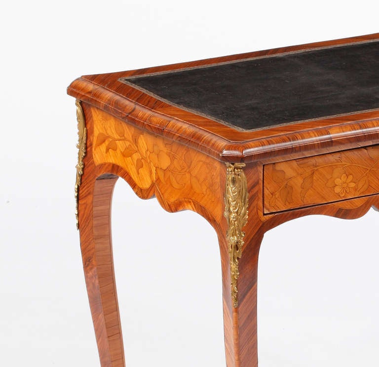 A Fine Louis XV Ormolu Mounted Kingwood and Fruitwood Marquetry Table a Ecrire
Mid 18th Century
Stamped I.M.Chevallier

Jean-Mathieu Chevallier, maitre in 1743

The rectangular top fitted with a black leather writing surface, the frieze with