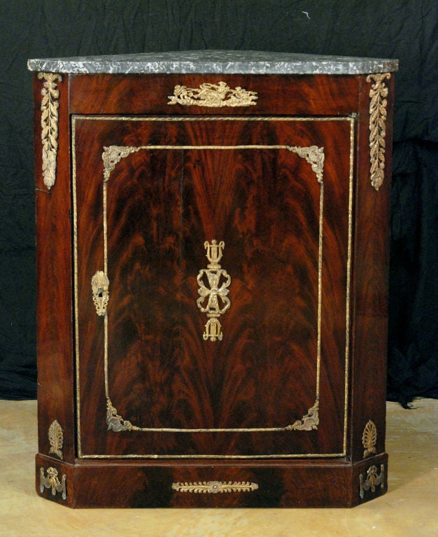 A French Empire Mahogany Corner Cabinet with Ormolu Mounts
