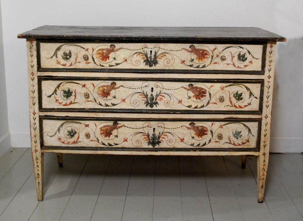 The faux-marble top above three drawers all resting on tapering legs, decorated throughout with great detail.

Height 40 in.  Width 58 in.  Depth 25 in.