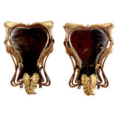 A Pair of Art Nouveau Carved Walnut & Parcel-Gilt Mirrors