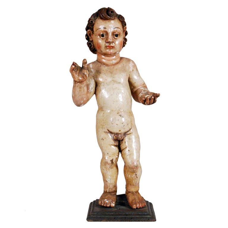 An Italian Carved Polychromed Figure of a Putto