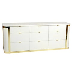A White Lacquered & Brass Accents Commode by John Stuart