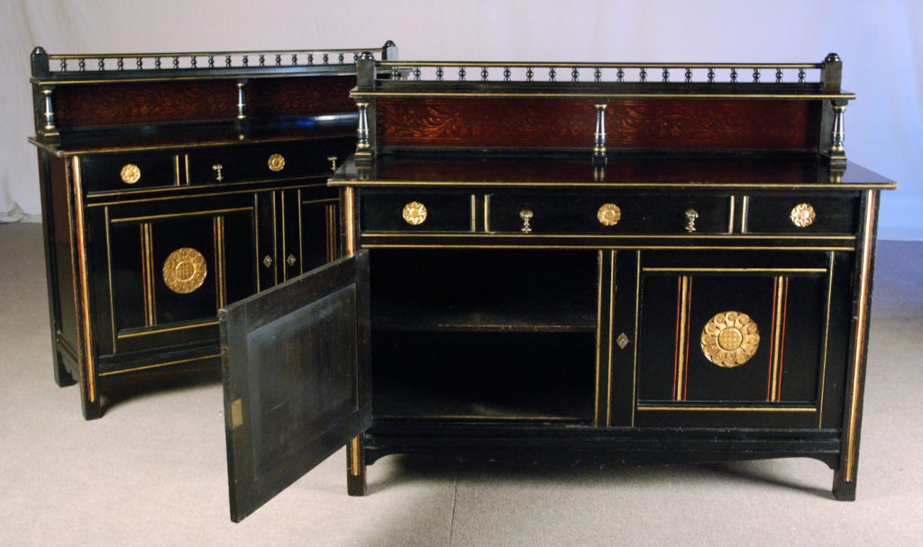 A Fine Pair of Aesthetic Movement Ebonised Wood Cabinets 
by Gillow designed by Bruce James Talbert
Circa 1867-1871

Height 49 ½ in.  Width 60 in.  Depth 19 ½

Each cabinet with an upper section with turnings and a back splash lined with