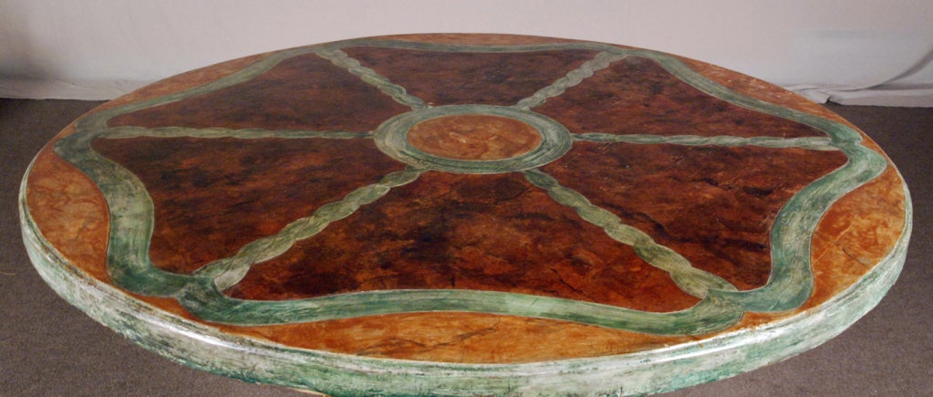 With a later round decorated top over three carved figures each with a symbol on each side, ending with paw feet on a later triangular plinth,
decoration refraiched,

The six symbols represented are a musical instrument, a figure of a man holding a