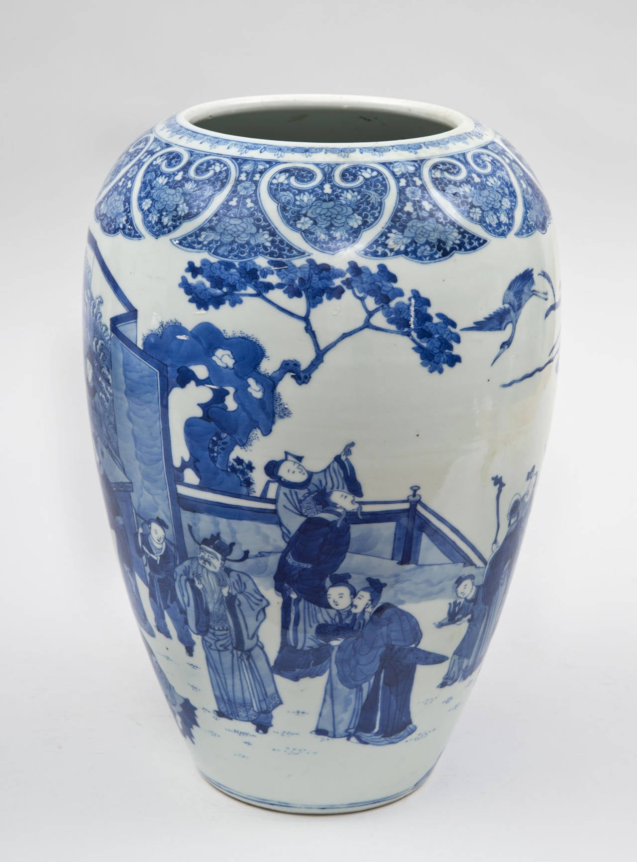 Blue and white porcelain ovoid shaped vase decorated with a continuous pattern of figures in various means of pursuit – playing games with a beautiful seven panel screen behind them, unfurling a scroll, bird watching beside a gnarled tree.