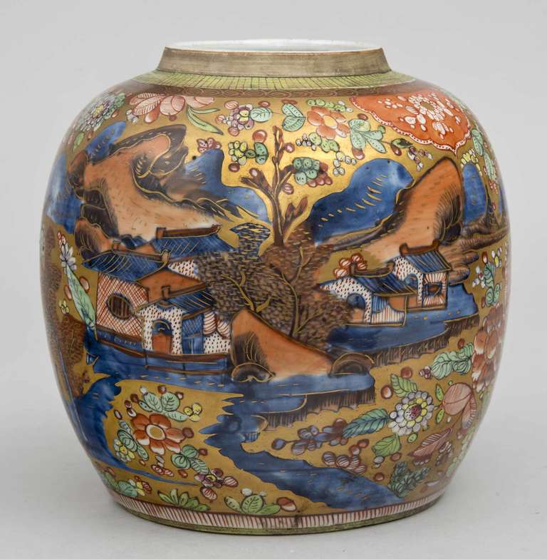 Chinese Qianlong period blue and white ginger jar that has been enameled or “clobbered” in the 18th century. The background is gilded with added colors of iron reds, yellow and green. Exotic fighting dragons decorate the back side. 

During the