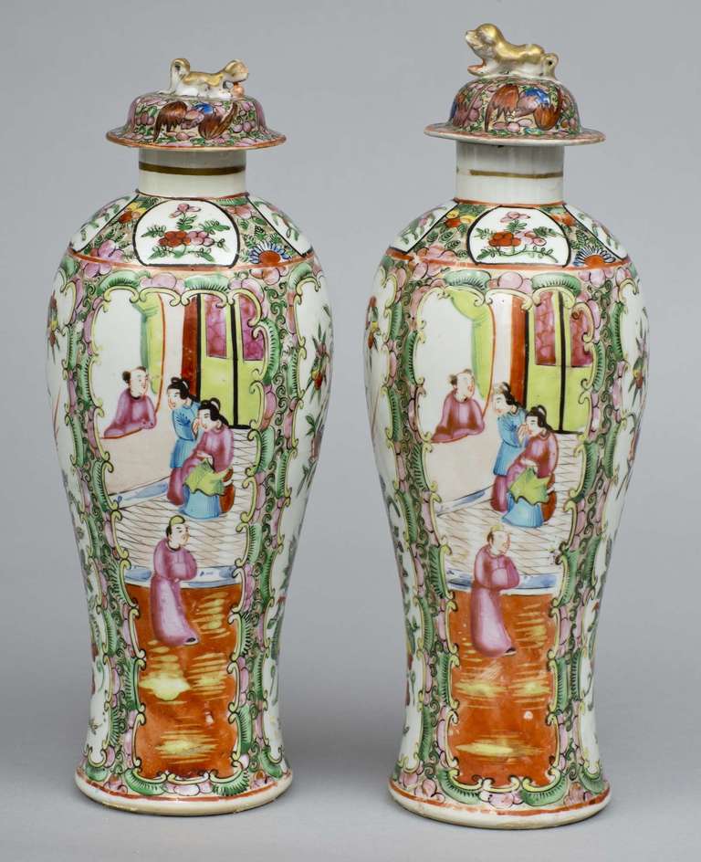 Pair Canton rose medallion porcelain baluster-shaped covered vases, the domed lids with foo dog finials, decorated with alternating panels enclosing figures in a courtly scene, birds and flowers.

Item #7256