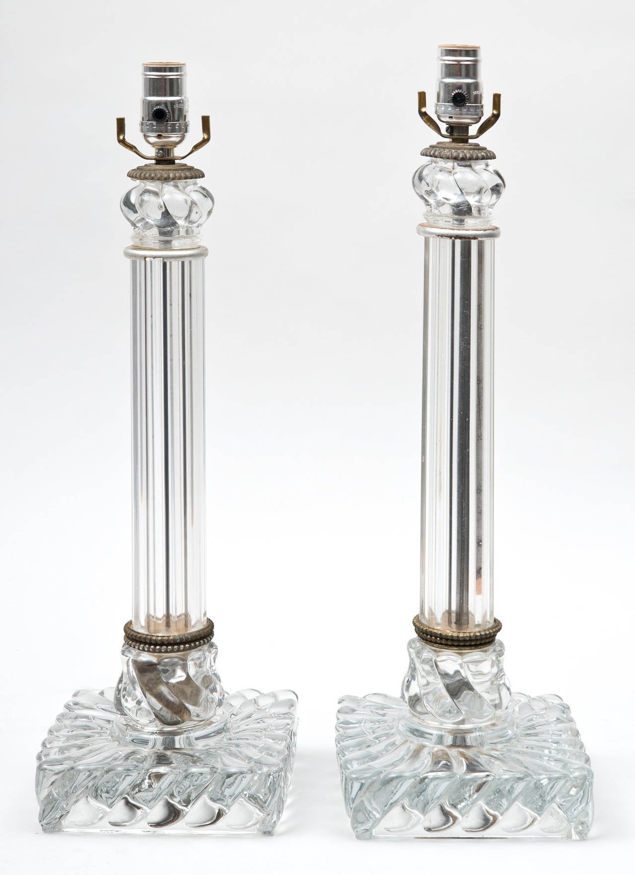 Baccarat style molded glass lamps with fluted columns and boldly swirled bases.

Item #7441.