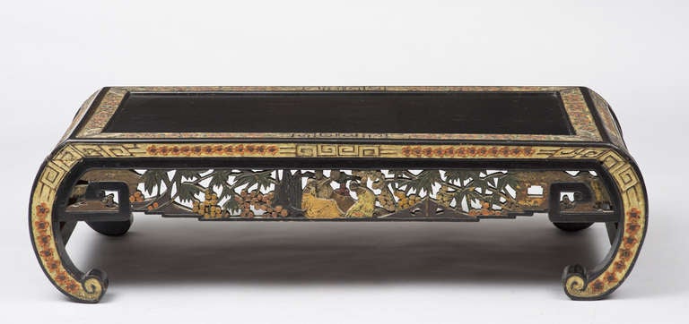 

Chinese black lacquered low table with carved and pierced aprons decorated with polychrome colors of figures, trees, foliage and flowers, on inward scroll ends or legs.

    
    
   
   

- See more at: