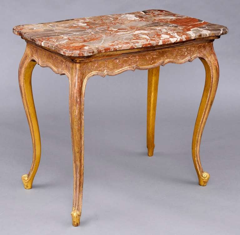 French giltwood free standing console or center table with serpentine-shaped molded breche marble top, shaped frieze on all sides, raised on cabriole legs and scrolled feet.