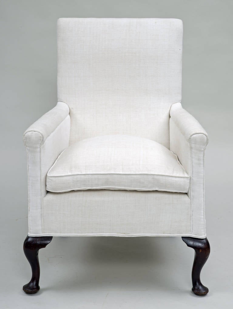 Early Victorian armchair with high straight back, rolled arms, loose cushion, deep apron, raised on mahogany cabriole front legs and curved square back legs, upholstered in heavy white linen. Very comfortable.

