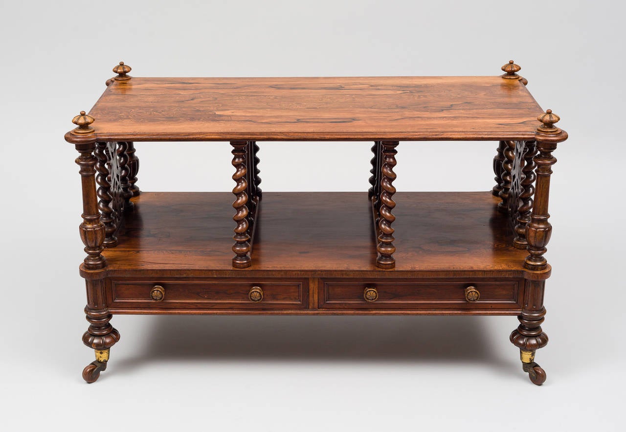 Georgian large rosewood canterbury, with three open divisions, the top is molded all around and has molded and protruding round corners with carved finials, four ring-turned and vase-shaped corner columns with fluted bases, carved and turned barley