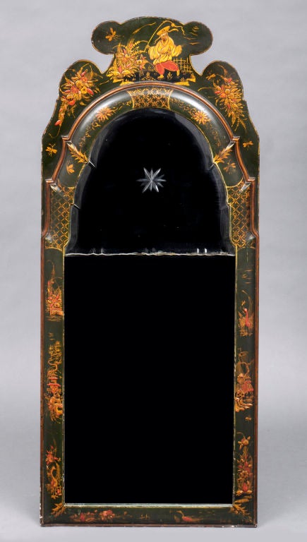 Green lacquered and gilded chinoiserie mirror, the two-piece bevelled and cut-glass plate within a cushion frame with shaped surmount, decorated with a colorful Chinese figure, flowers, pagodas and birds.