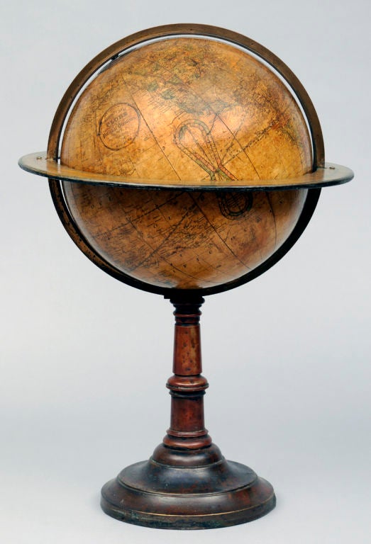 Large American 12 inch terrestrial globe with brass meridian ring and paper on metal horizon ring showing the months of the year with corresponding signs of the Zodiac on copper pedestal base. The globe is inscribed 