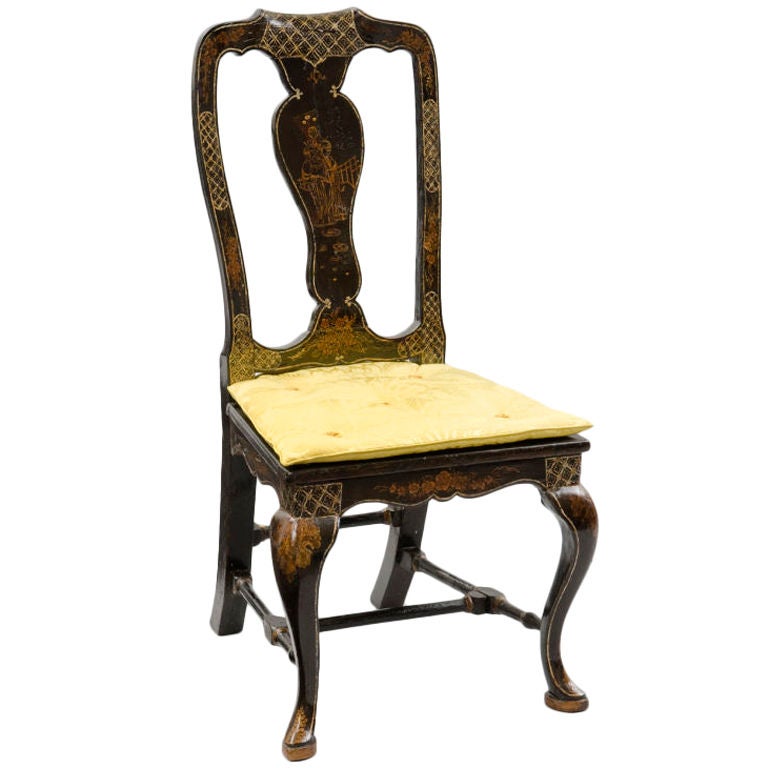 Venetian black lacquered chinoiserie side chair with shaped top rail, vasiform splat over a silk upholstered cushion seat, scalloped apron on all sides, cabriole legs joined by turned stretchers, terminating in pad feet on oval blocks. The whole