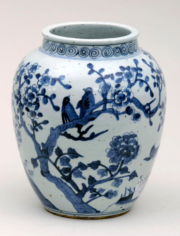 Chinese blue and white Shunzhi porcelain vase decorated with Hawthorn branches, hollow rock, birds and, butterflies, the neck decorated with a swirl pattern.