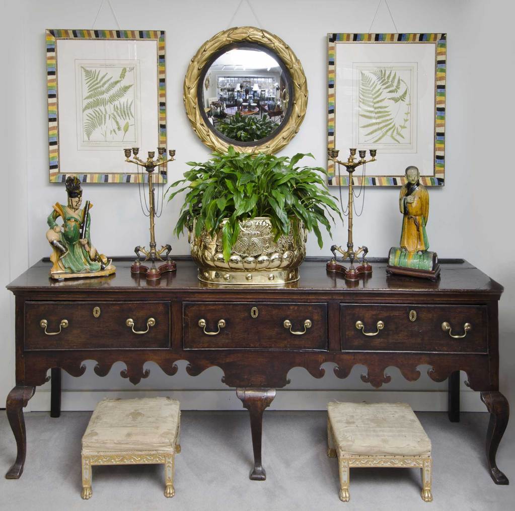 Regency mahogany knee hole ladies writing desk with very faded greenish gold gilt-tooled leather top with molded edge. One drawer above knee hole is flanked by two drawers on either side, with original brass knobs, raised on turned legs with brass