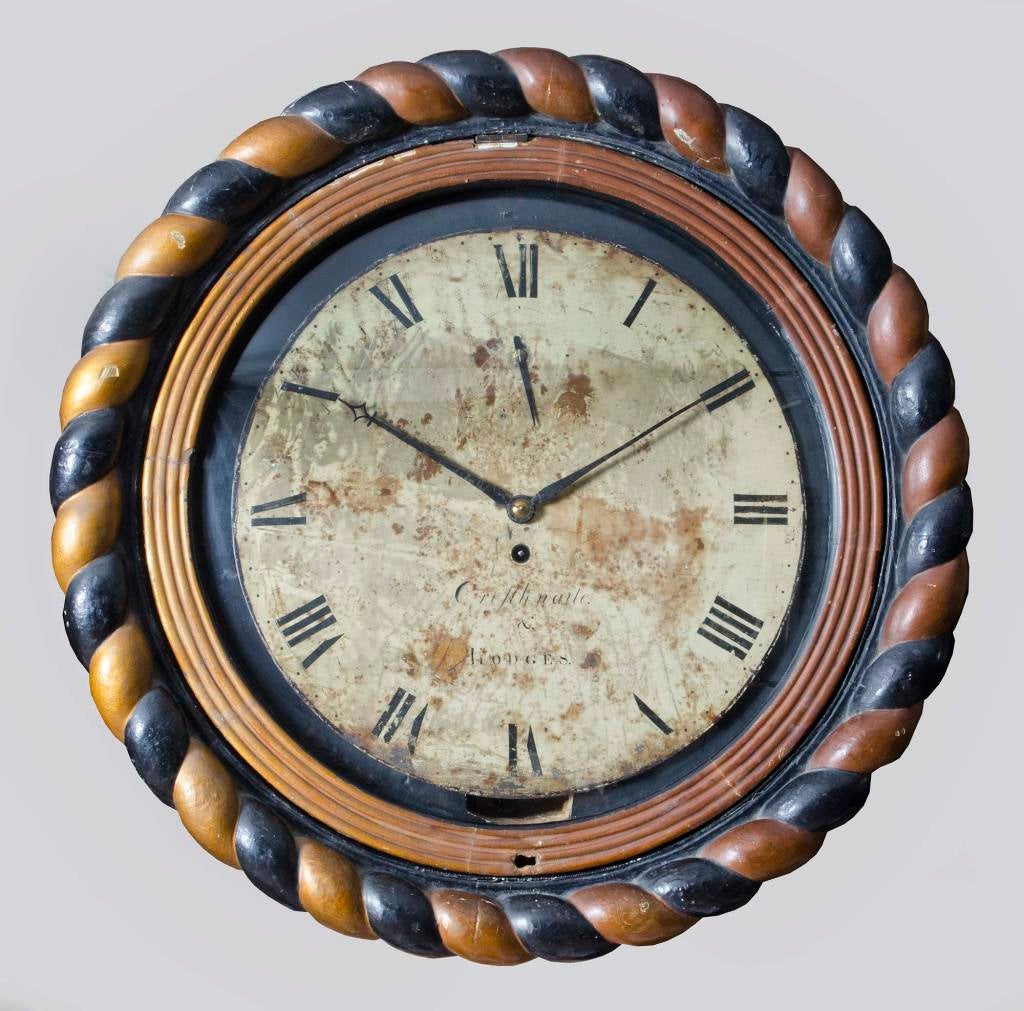 Irish dial wall clock signed on the painted iron dial by Cresthwaite and Hodges. The case has a carved gilded and ebonized rope-shaped surround. The gilded reeded bezel, which lifts to open, has a convex glass and a lock set in the bottom.
Fusee