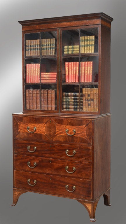 George III mahogany secretaire bookcase having two astragal-glazed doors with beaded brass molding enclosing an interior with two adjustable shelves, below a molded cornice with wide band of satinwood with ebony stringing, the base with three