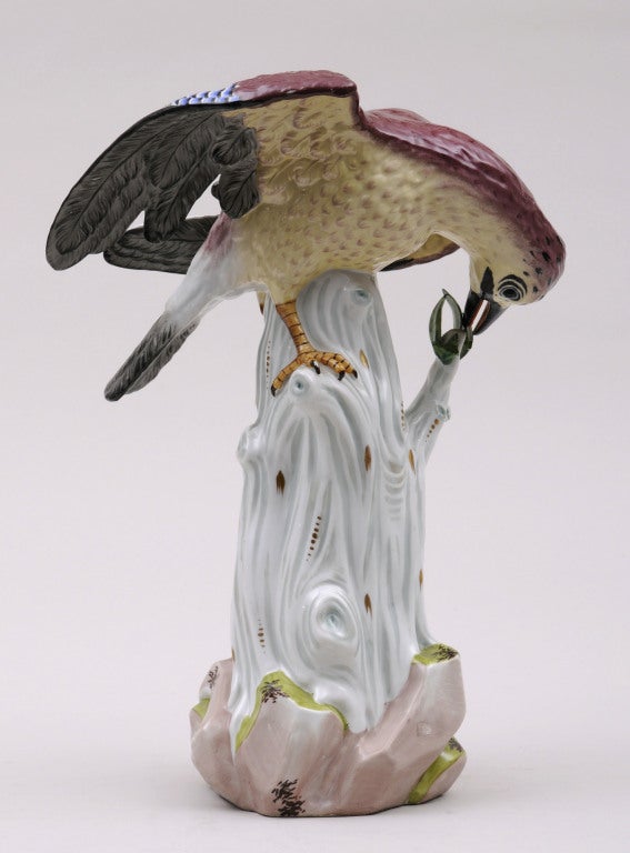 Dresden porcelain bird perched on a tree stump eating leaves painted in mauve, blue, black, cream and gray.
Painted by Helena Wolfsohn under the aegis of Augustus Rex. Signed on the bottom: AR.