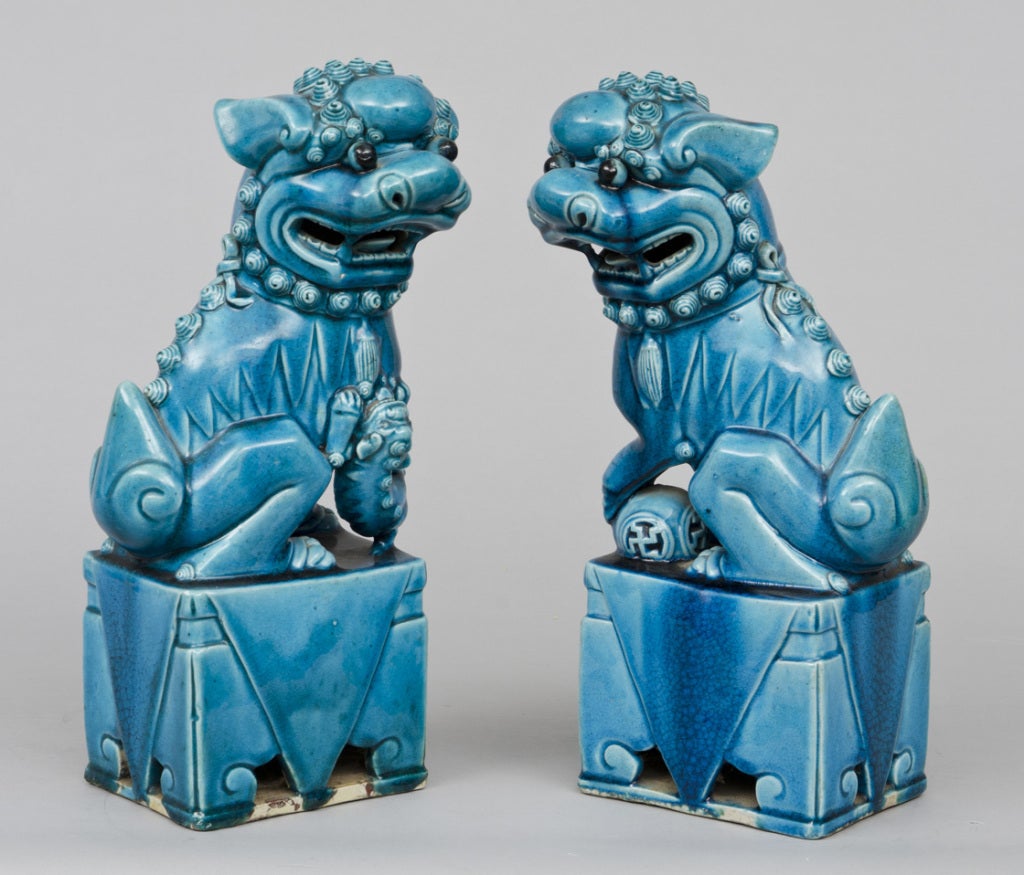 Large pair Chinese biscuit turquoise-colored male and female foo dogs.