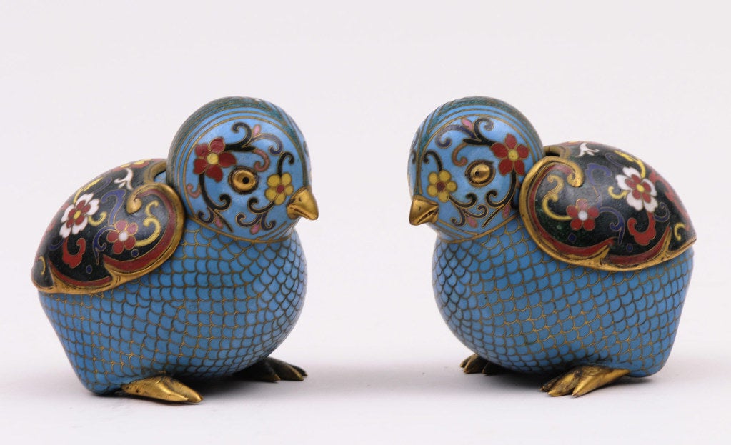 Charming pair of very fine quality small Chinese cloisonne enamel boxes in the form of quails with removable lids, decorated with floral patterns in red, white, pink, green and yellow on a turquoise ground with gilded beak and feet.
Cloisonne is a