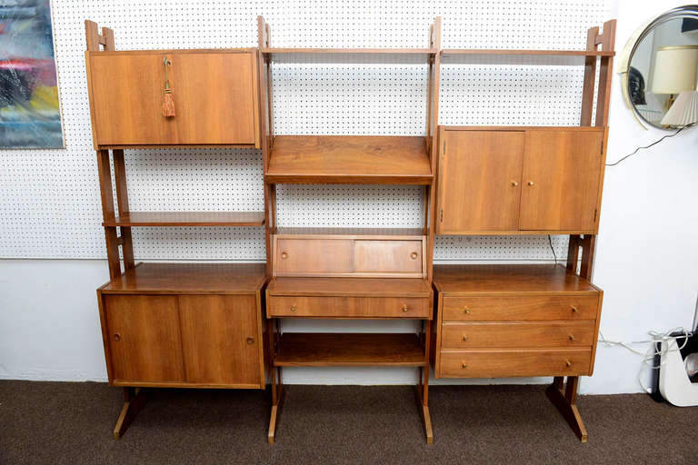 This Danish Modern Free-Standing Wall Unit with his beautifull original finish can also be used as a room divider as the back is also finish. The configuration can be adjusted. Original key for locking door included. This one-of-a-kind set of