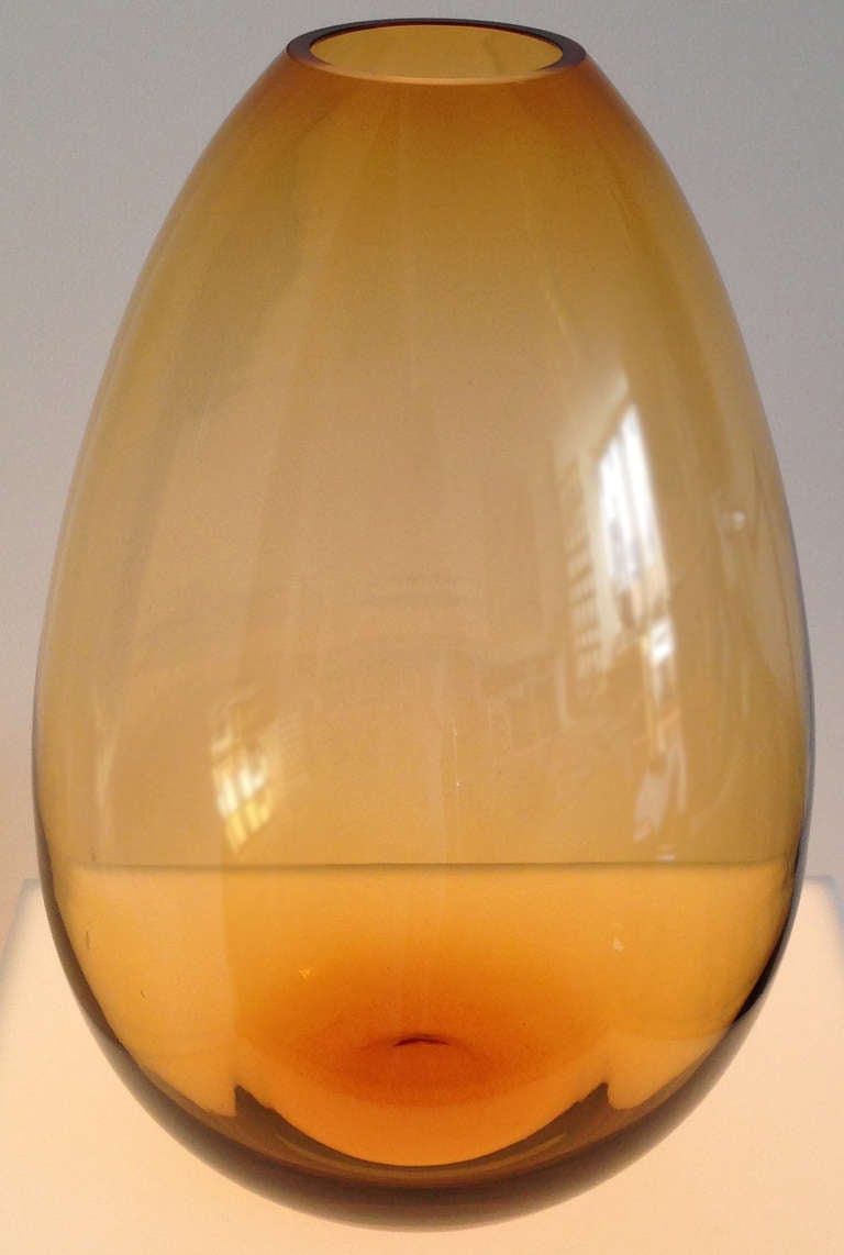 A jaunt through tall pines with the crackle of needles underfoot, beholding orbs of resin illuminated by the sun. A moment of childhood bliss captured in this Amber tear drop art glass vase in the manner of Per Lutken for Holmegaard.  Hand blown