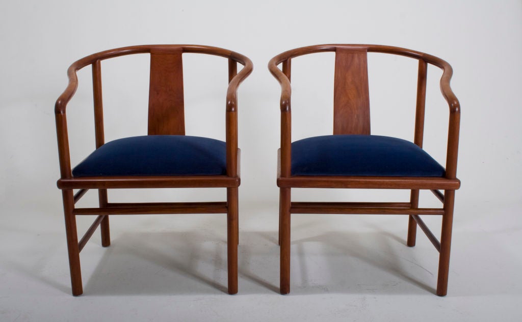 An exquisitely crafted pair of horseshoe-backed rosewood chairs with vibrant blue velvet seat. Stunning natural woodgrain is revealed upon close inspection.