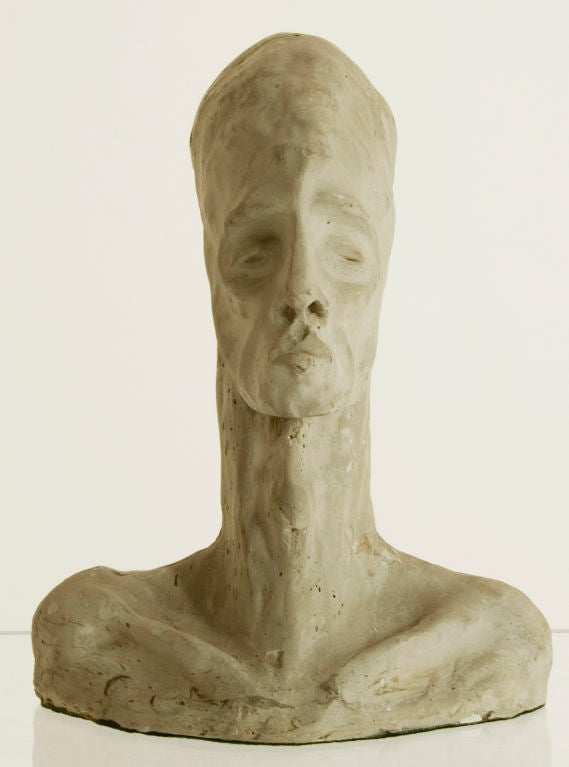 This plaster bust, of substantial weight, is primitive in style and bears intentional texture on its surface.