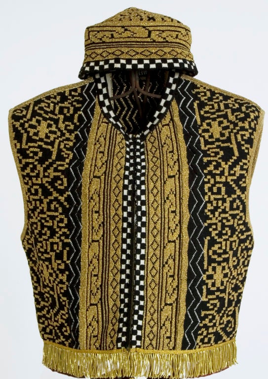 A vintage metallic-knit Jean Paul Gaultier 'Equator' hat and vest set. The vest features gold fringe trim and a fabric tag on its back. It's labeled size 42, and is made in Italy. Vest zips up front. The matching hat is also sized 42 and is designed