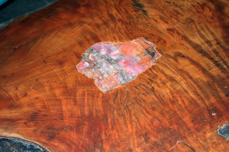 We found a wonderful redwood coffee table from the 1970's with inlaid pieces of petrified wood pieces. It had a horrible layer of acrylic resin which we had stripped down. The legs needed to be restored as well. A pretty organic table.