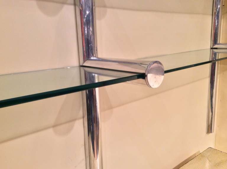 A nice aluminum Orba shelf unit by Janet Schweitzer for the Pace collection. Two of the glass pieces are new and slightly thinner.