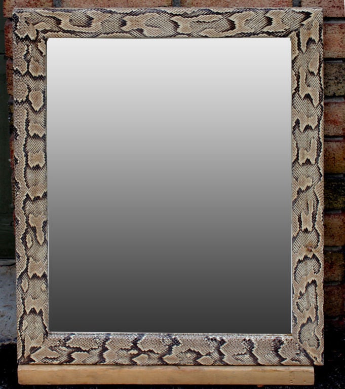 A nice python snakeskin covered mirror. The mirror is new as we had to replace it. Very much in the manner of Karl Springer, although the skin here is very textured.