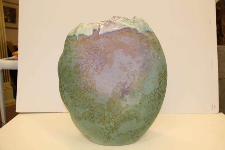 A large and quite beautiful Tony Evans raku fired pottery vase signed on the base.  Pretty colors and still vibrant.
